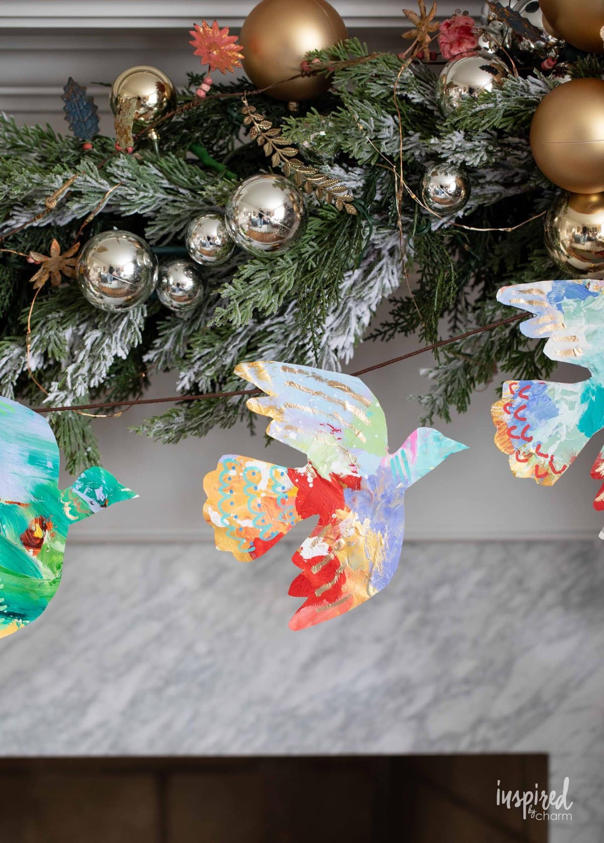 Christmas garland made of painted colorful doves.