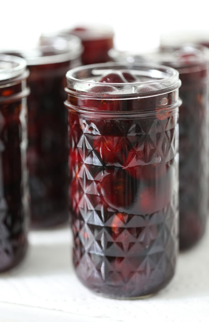 Homemade Bourbon Soaked Cherries in a canning jar.
