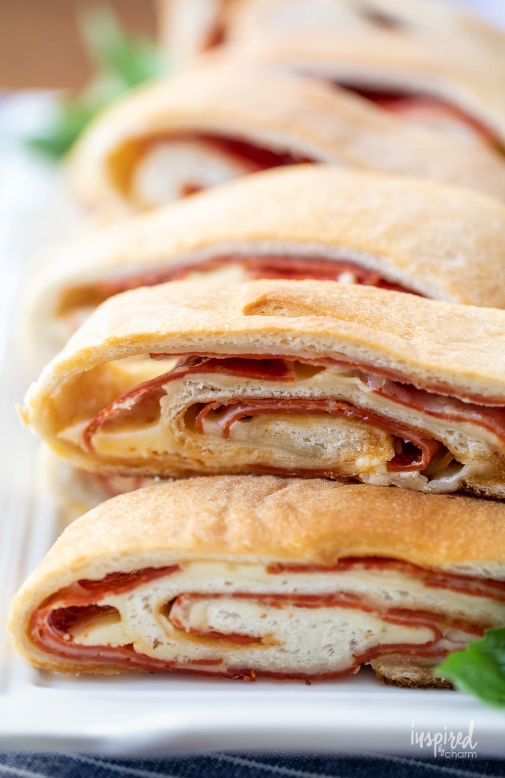 close up of pepperoni bread on a platter. 