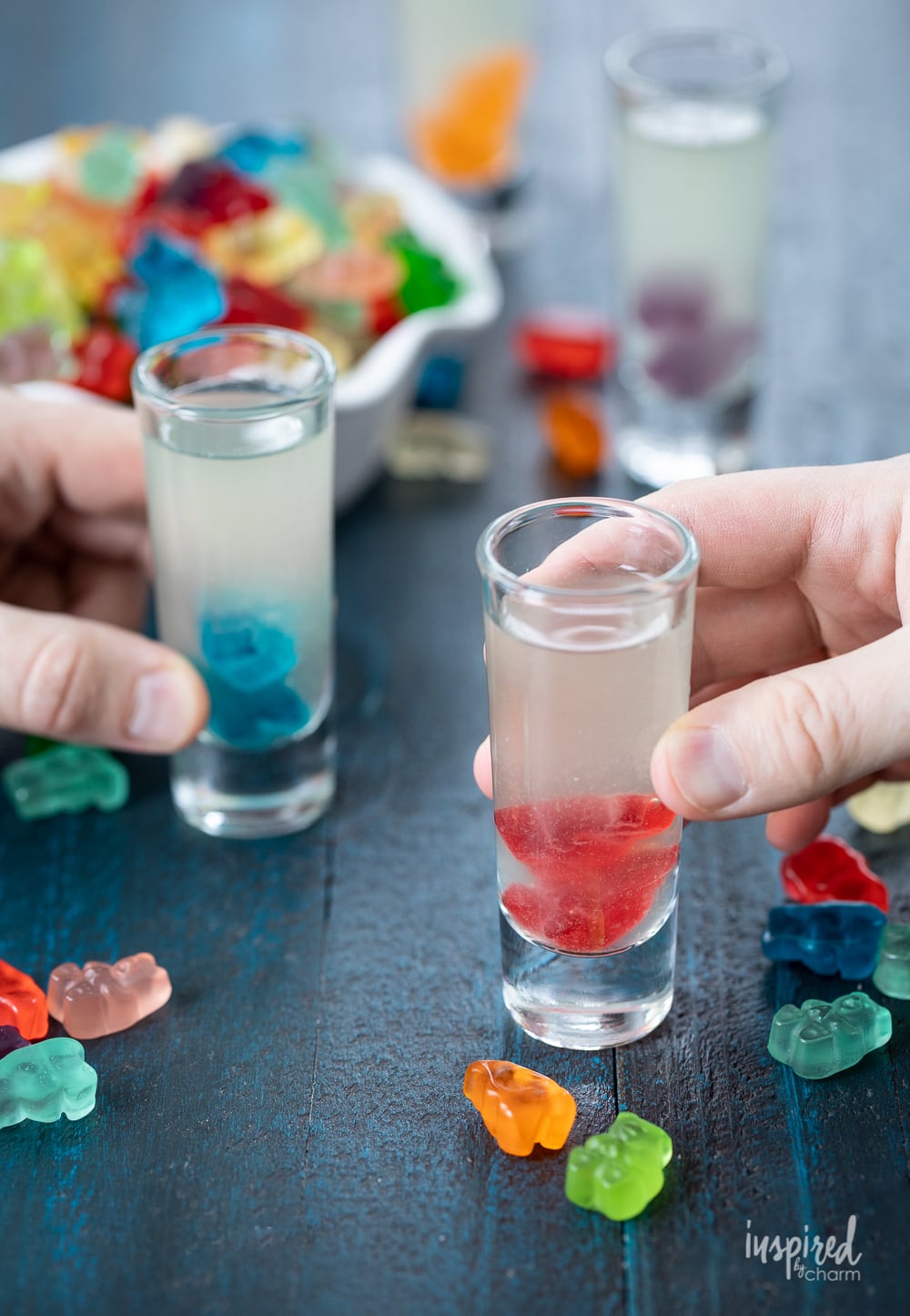 hands holding gummy bear shots