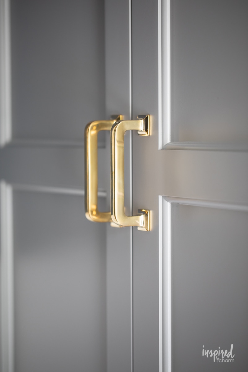 farrow and ball pigeon painted on cabinet doors with brass hardware.