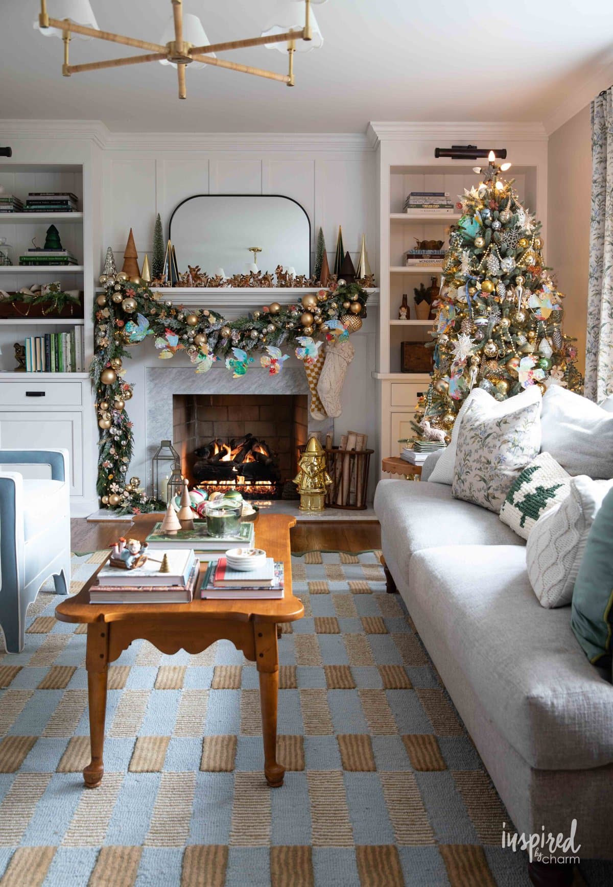 living room with christmas mantel and christmas tree decorated.