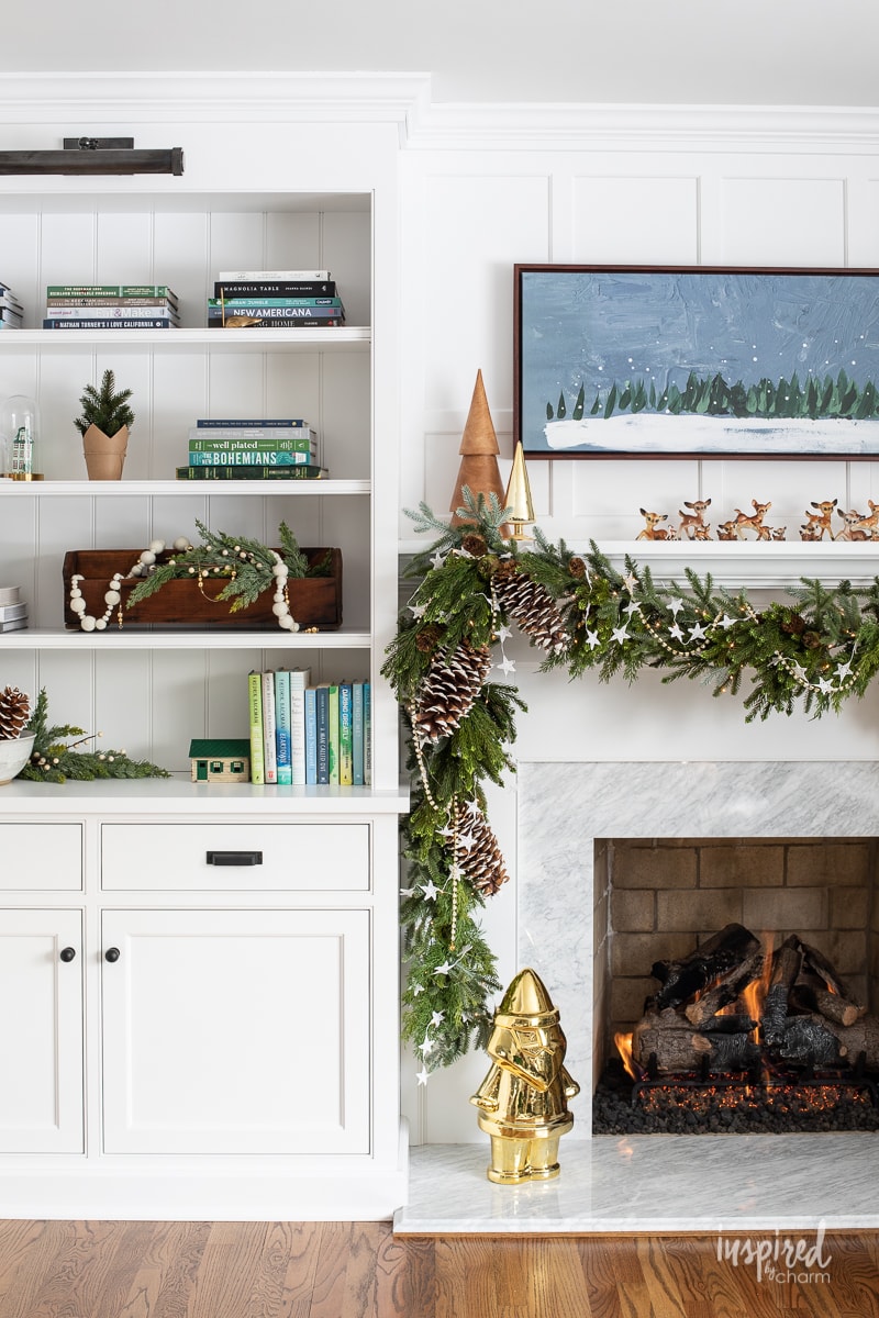 Living Room Christmas Mantel Decor #livingroom #mantel #christmas #fireplace #holiday #decor #bookshelf #bookcase #garland