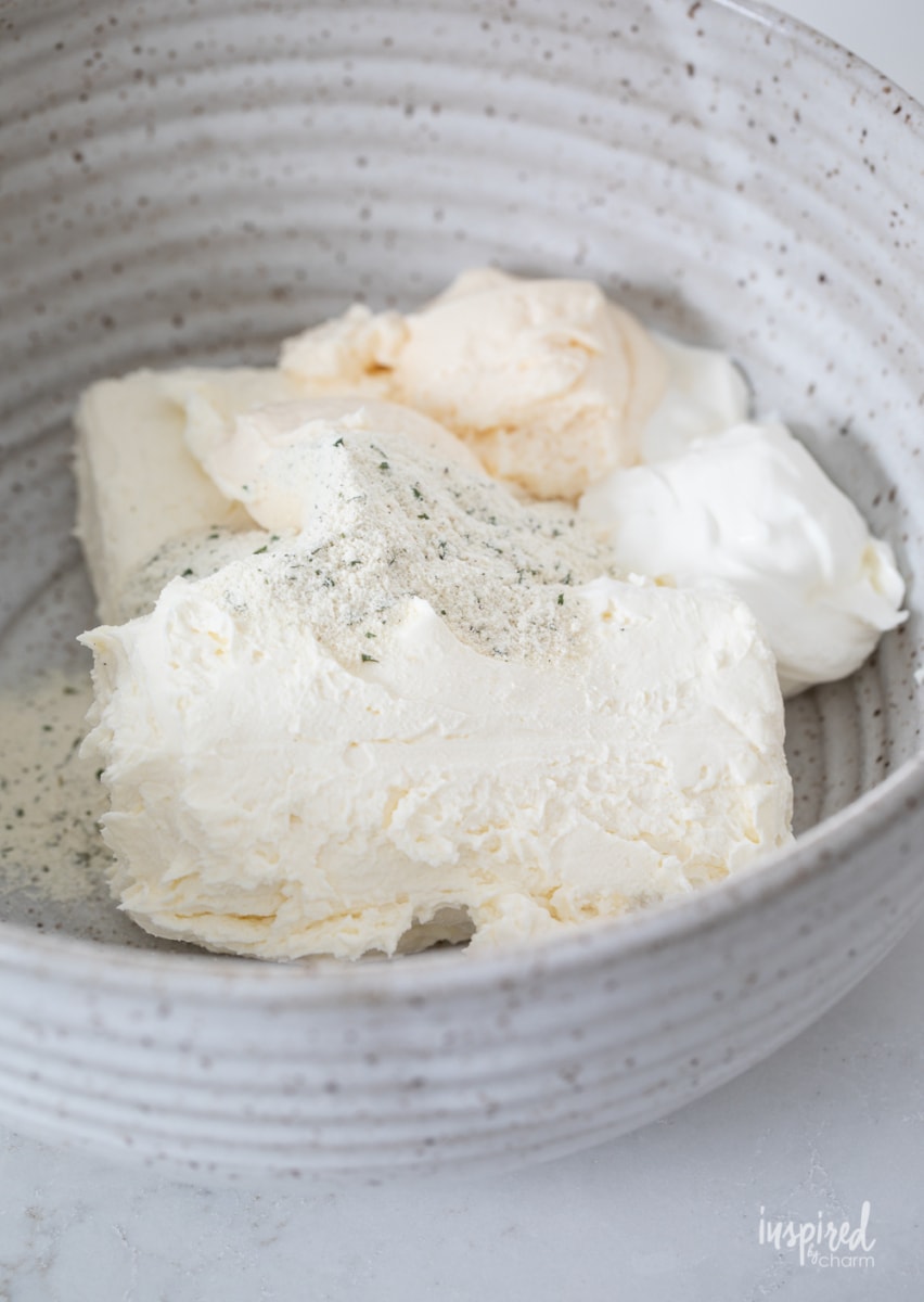 making veggie pizza dip in a bowl