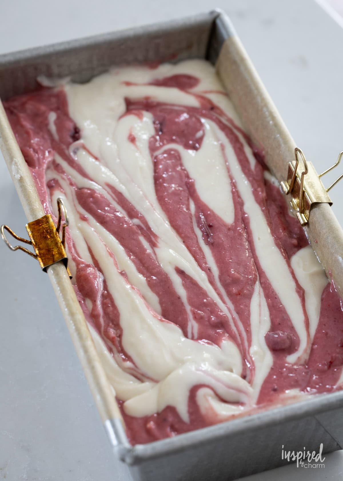 swirled Cranberry Marble Loaf Cake batter in a loaf pan.