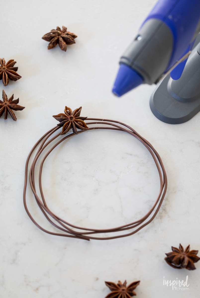 gluing star anise to wreath.