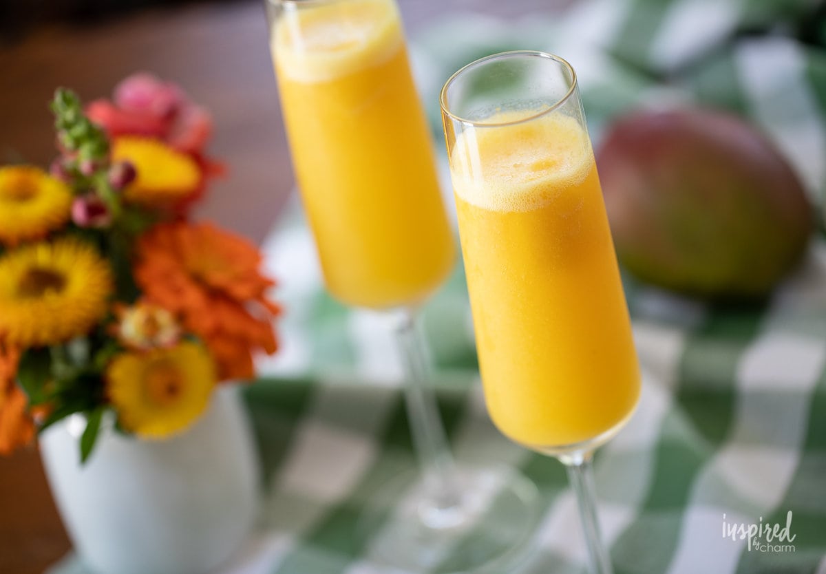 two Mango Mimosas in champagne glasses.