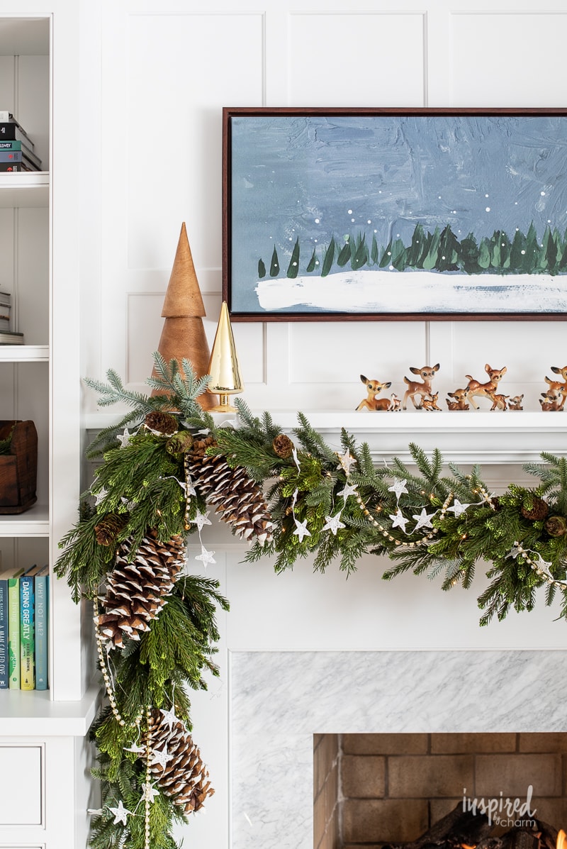 Living Room Christmas Mantel Decor #livingroom #mantel #christmas #fireplace #holiday #decor #bookshelf #bookcase #garland