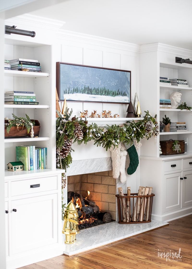 Living Room Christmas Mantel Decor #livingroom #mantel #christmas #fireplace #holiday #decor #bookshelf #bookcase #garland
