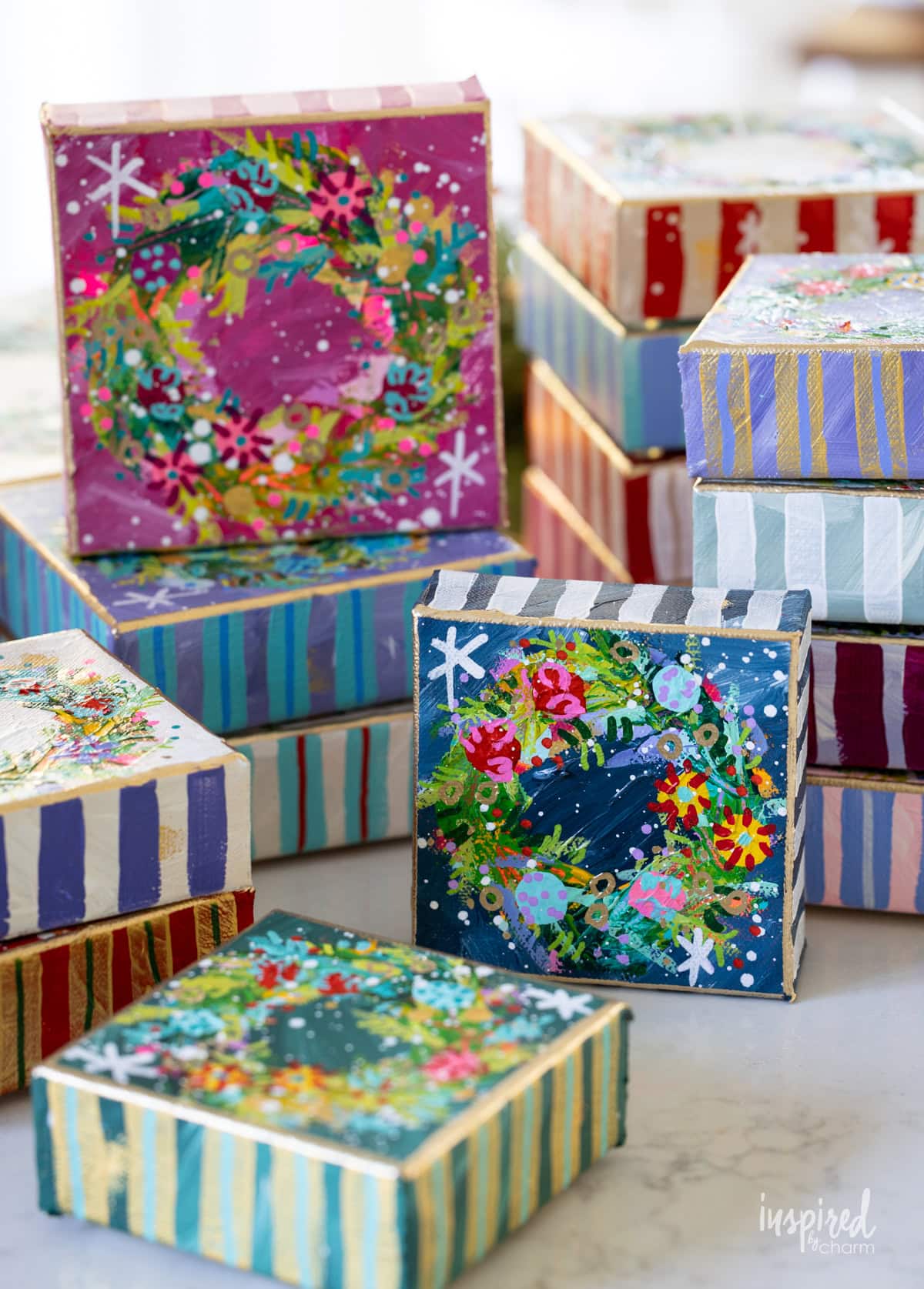 Christmas wreath paintings on small canvases. 