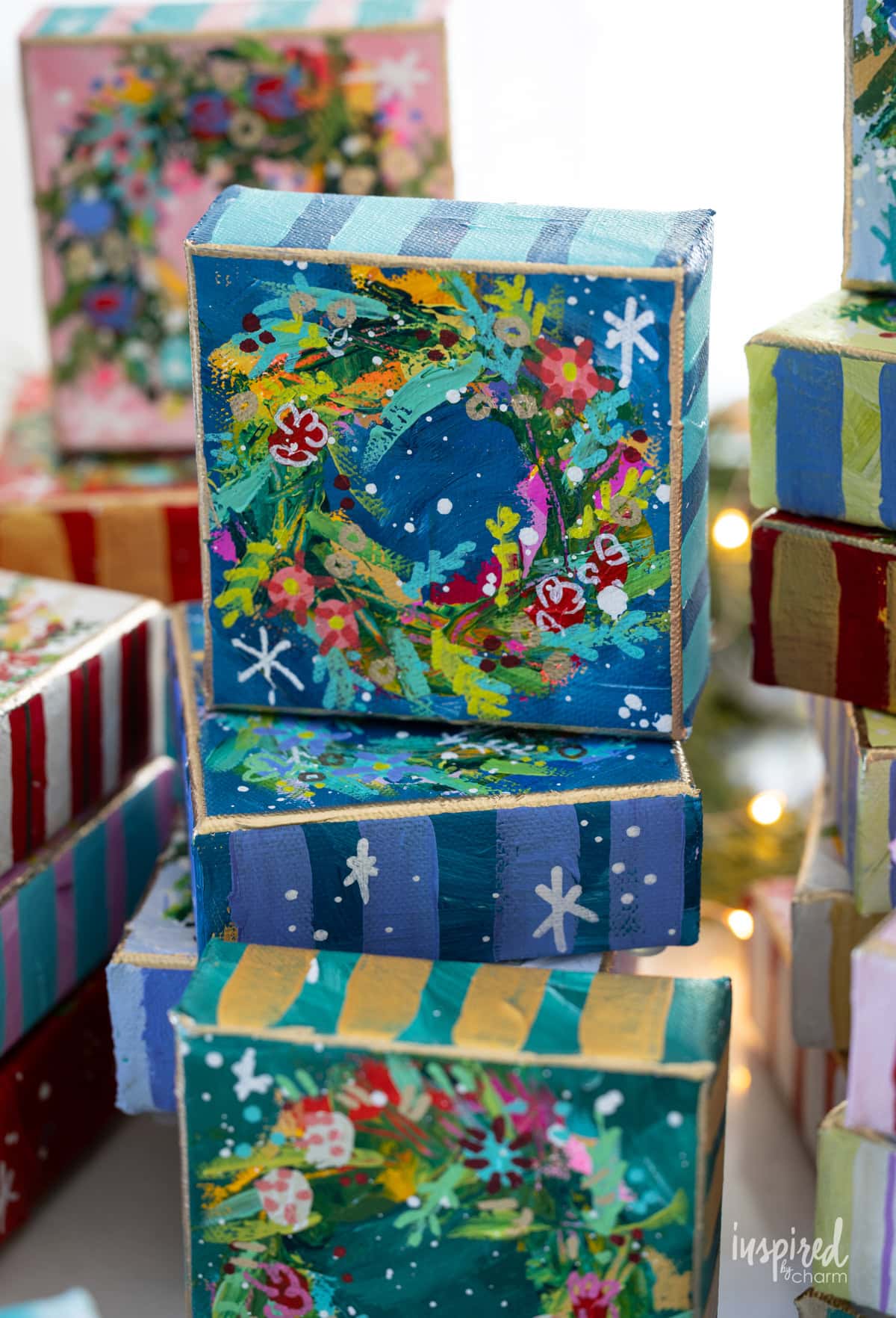colorful christmas paintings done on small canvases.
