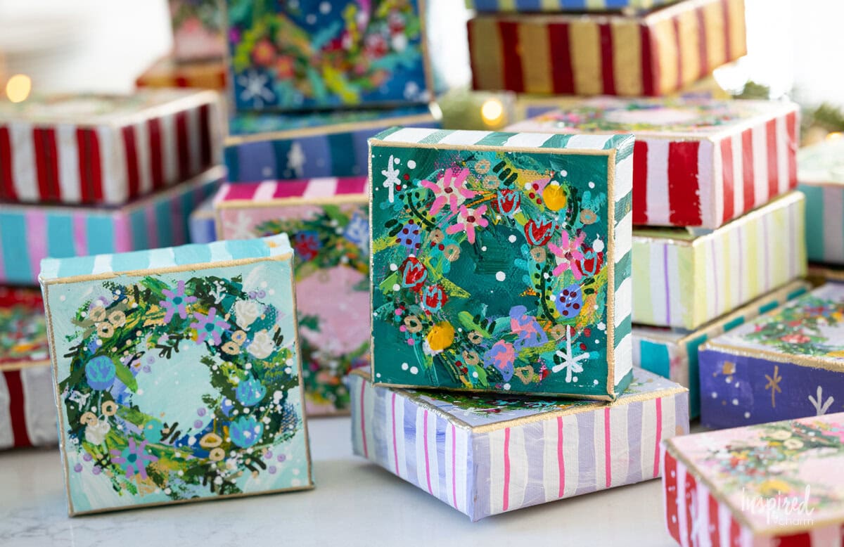 small painted canvases with Christmas wreathes on them. 