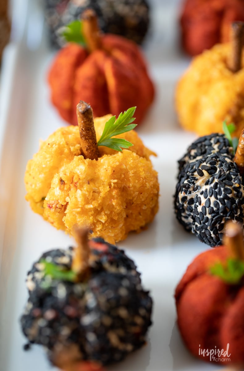 Mini Pumpkin Cheese Balls fall appetizer served on a white plate.