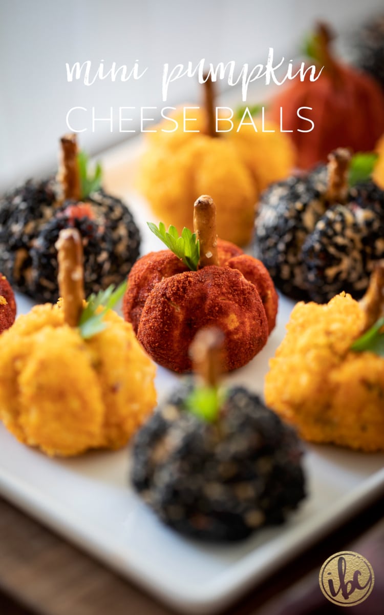 three different Mini Pumpkin Cheese Balls on a plate.