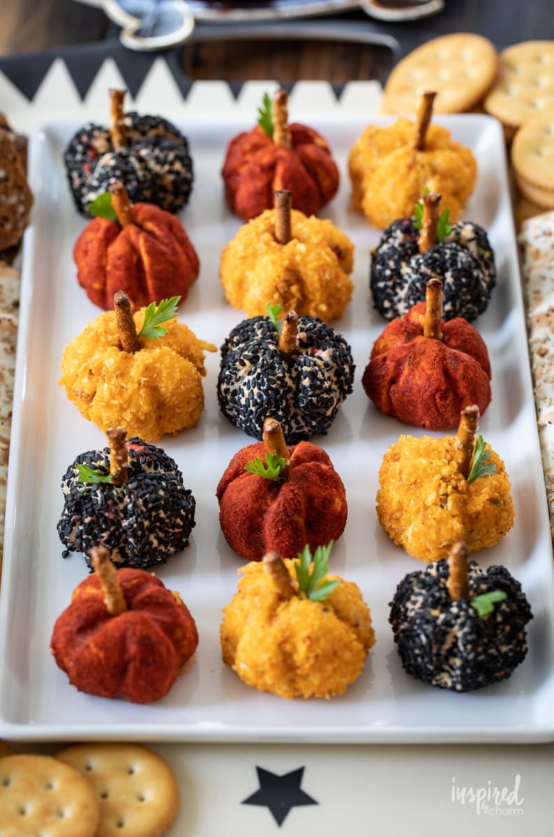 plate of Mini Pumpkin Cheese Balls served with crackers.