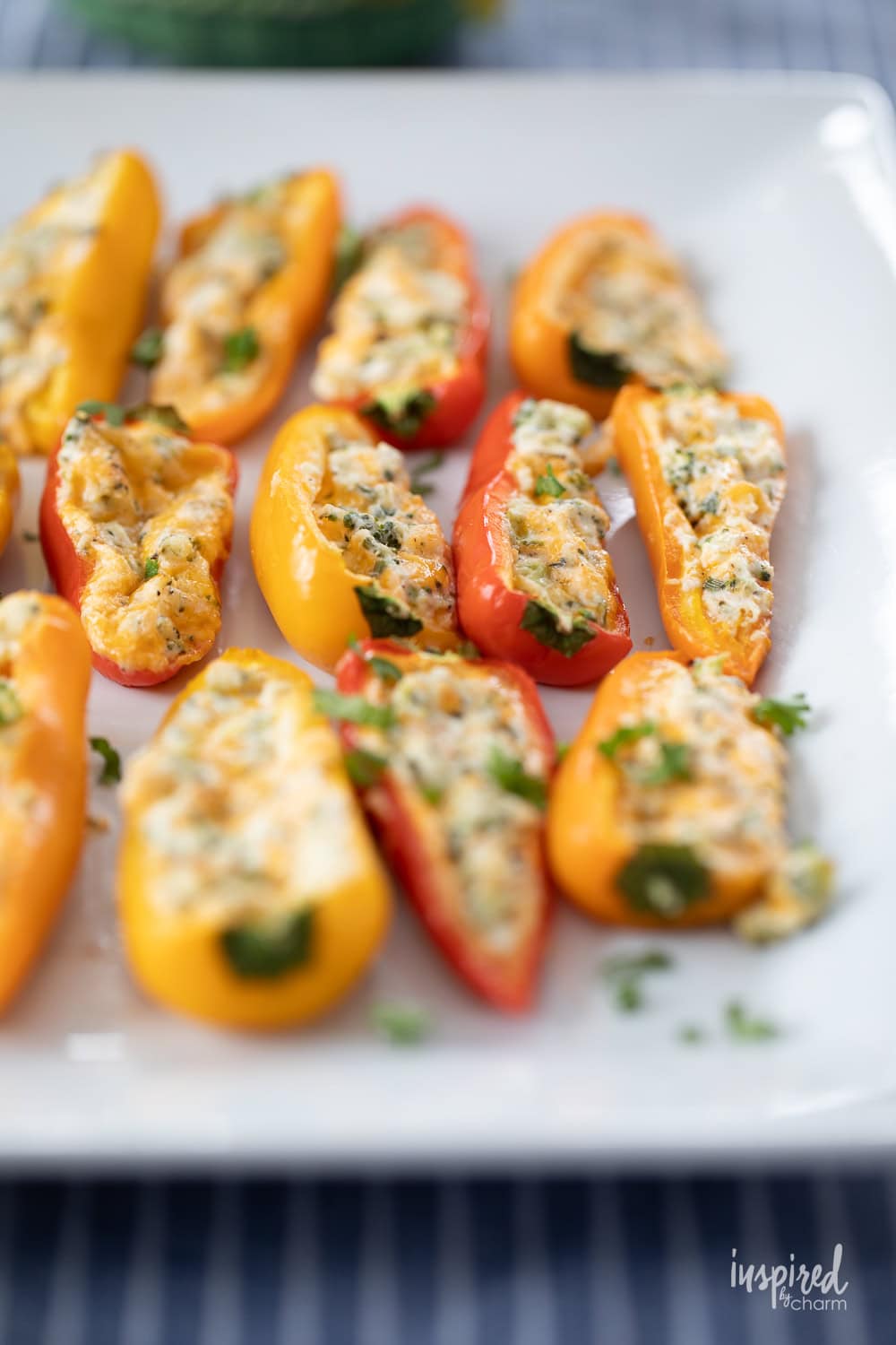 cheese filled mini peppers served on a plate.