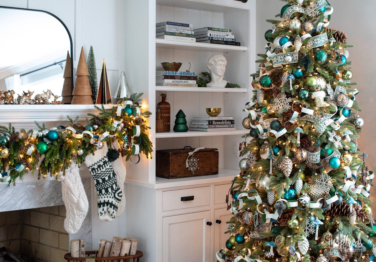 christmas tree in front on mantel and bookcase.