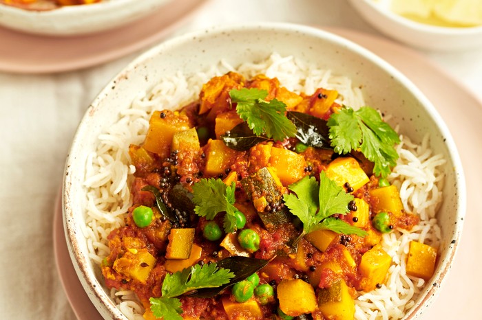 Two Bowls of Courgette Curry on a Bed of Rice