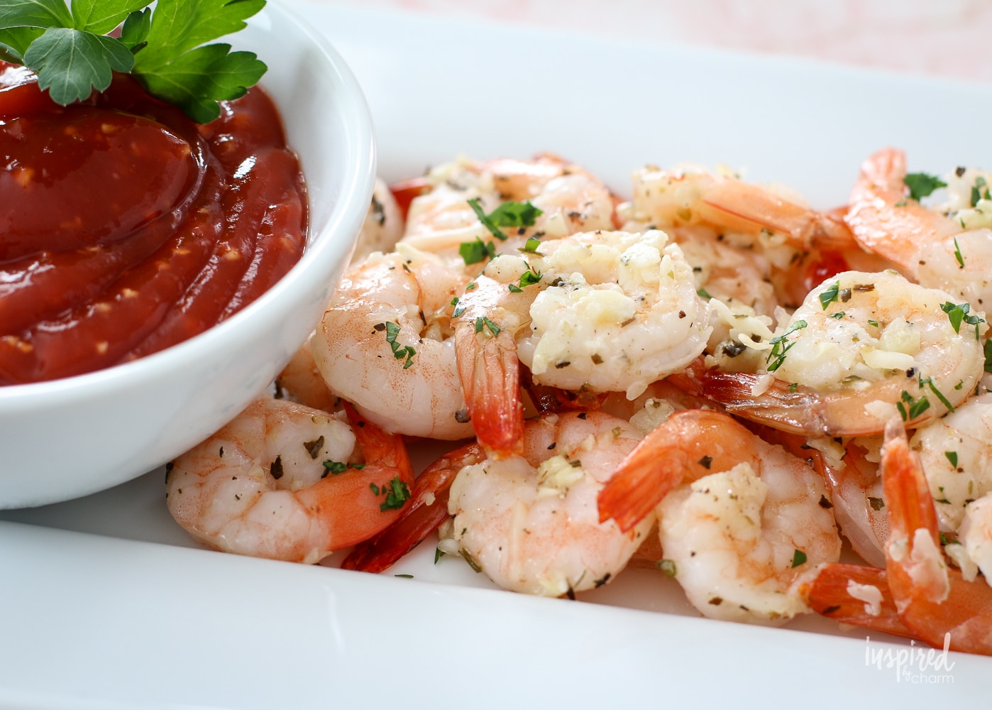 plated with roasted shrimp and a bowl of cocktail sauce.