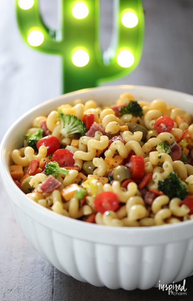 the best pasta salad recipe served in a large white bowl on a wood table. 