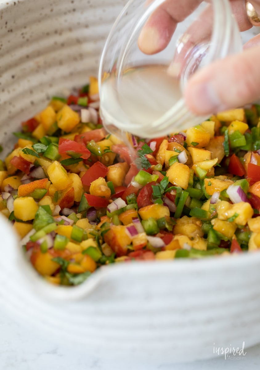 Spicy Peach Salsa in a bowl with tortilla chips.
