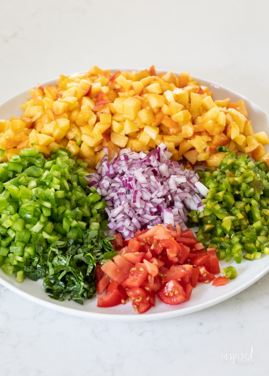 Spicy Peach Salsa in a bowl with tortilla chips.