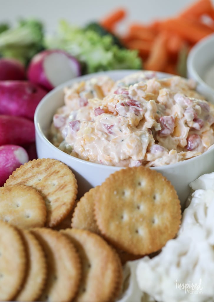 Really Good Pimento Cheese in a bowl with crackers and vegetables. 