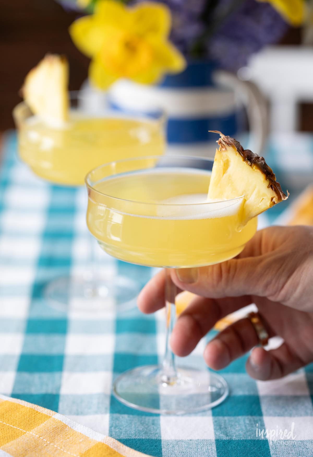 hand holding onto a pineapple mimosa.