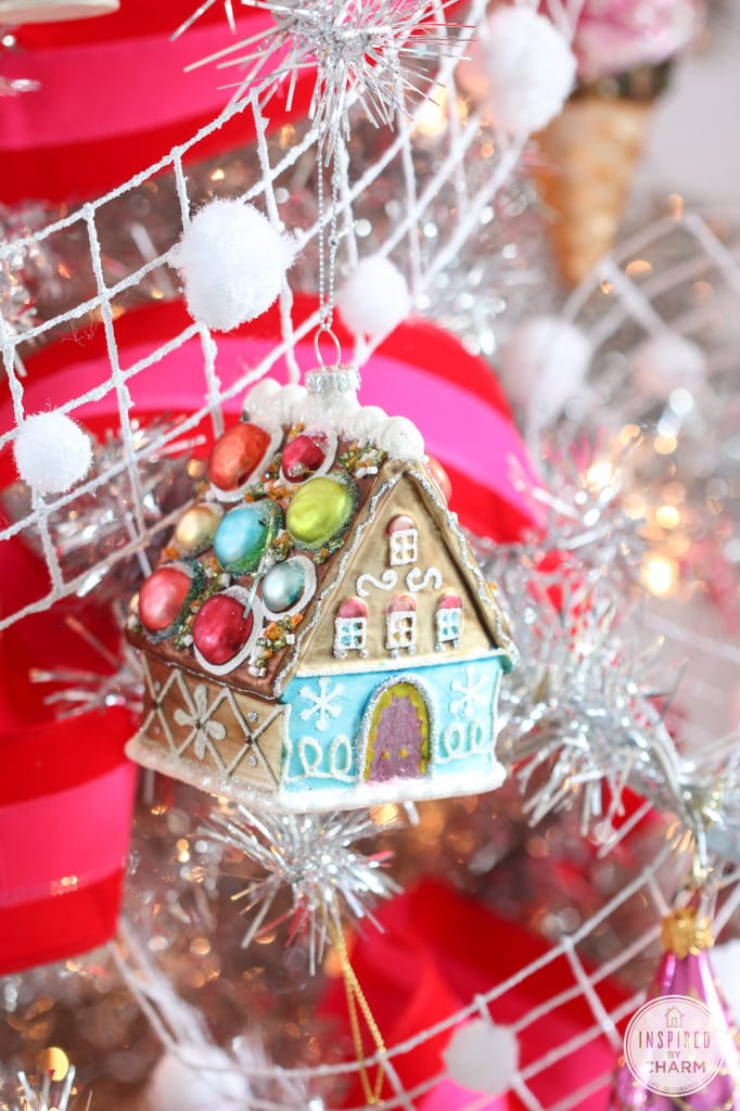 gingerbread house ornament hanging from a branch