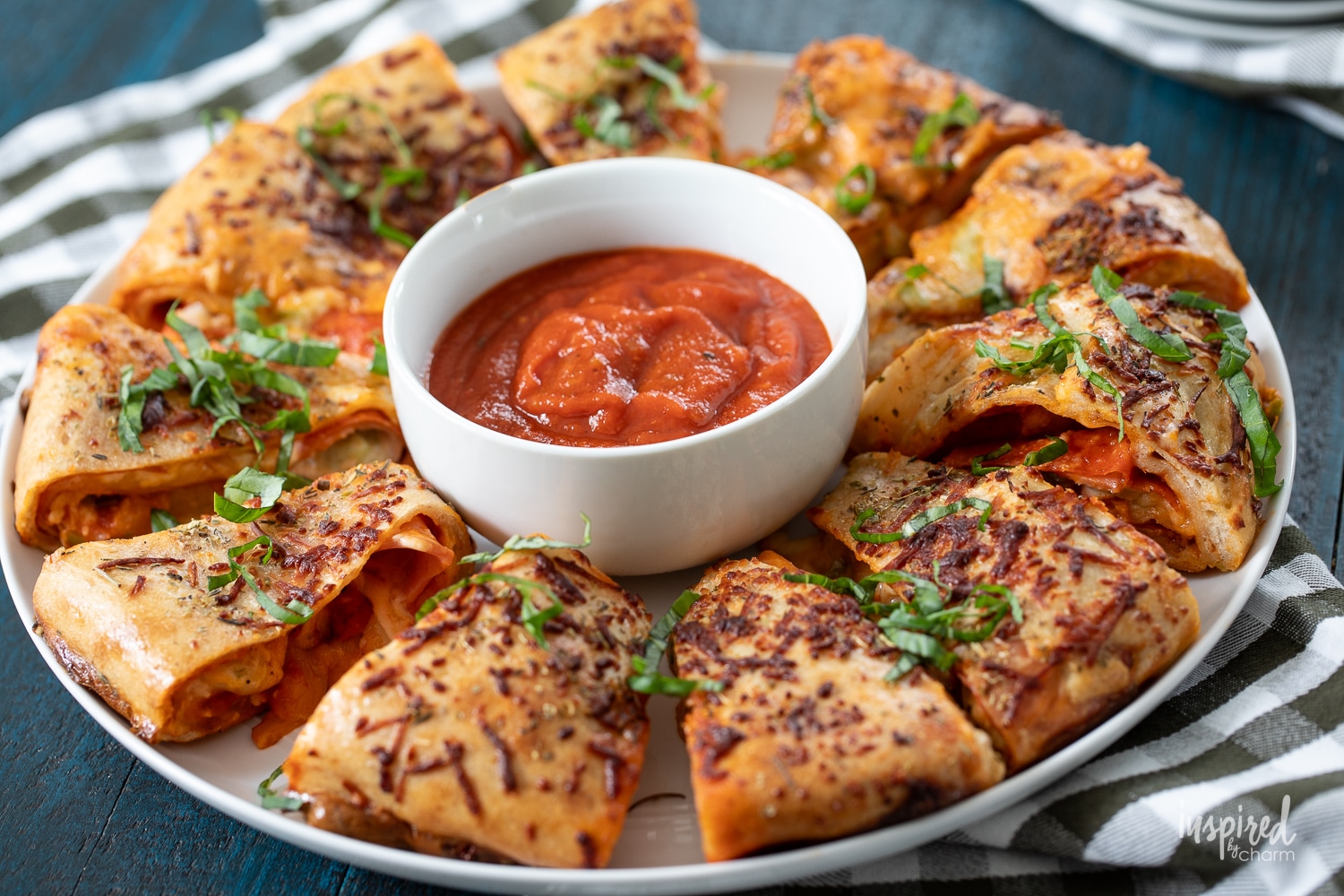pizza ring on a round plate with a serving of pizza sauce.