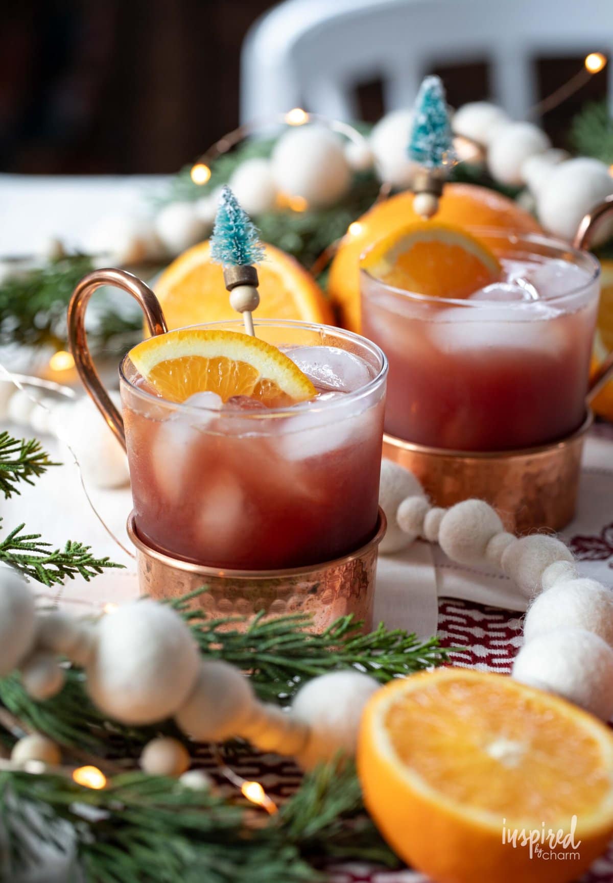 Pomegranate Bourbon Smash Cocktail in glass and copper mugs.