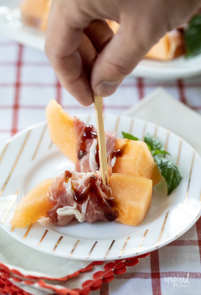 Prosciutto Melon Bites on white plate.