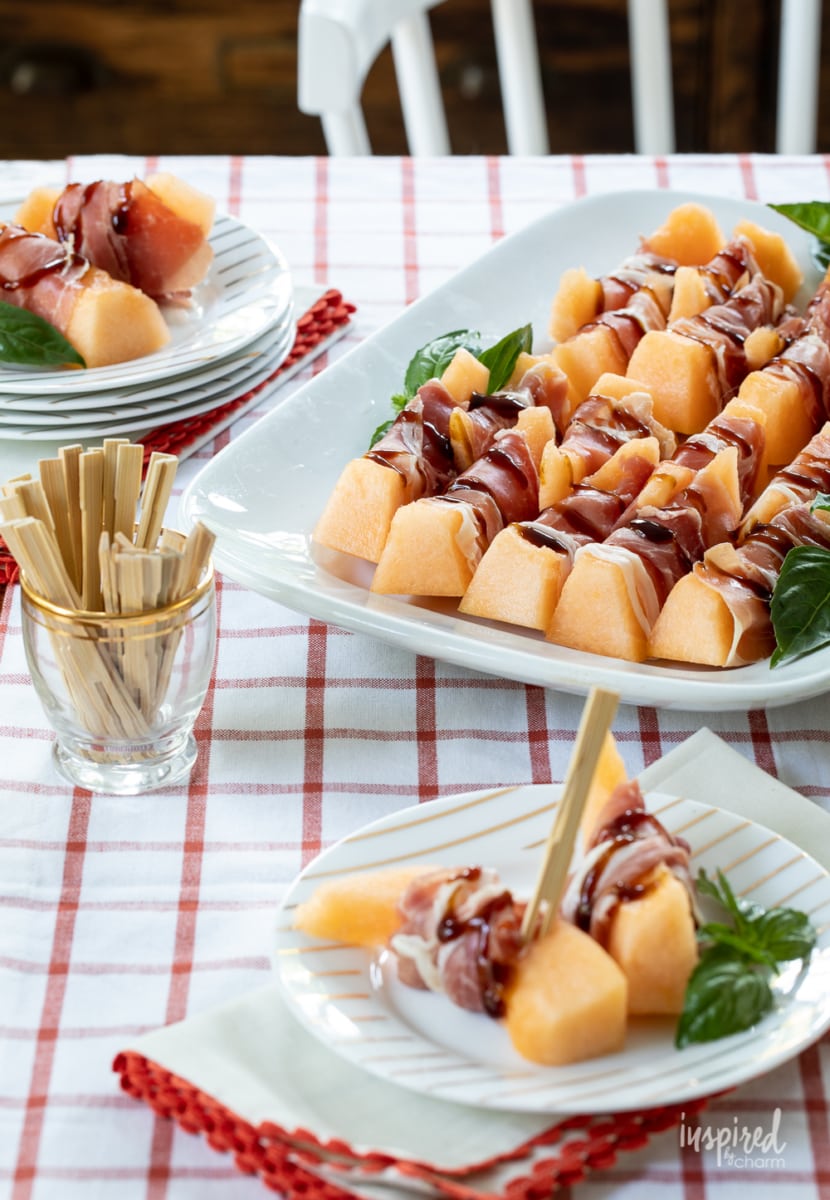 Prosciutto Melon Bites on white platter.