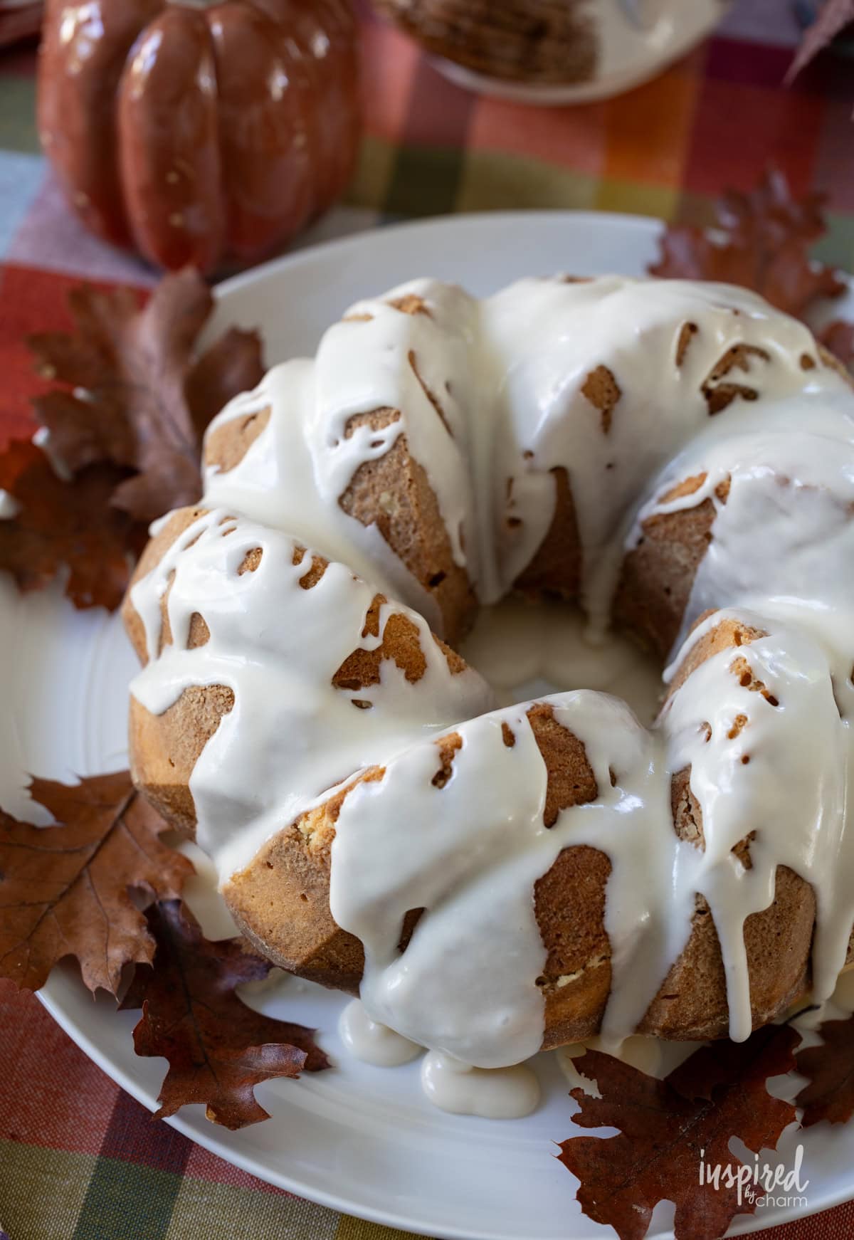 Spiced Cream Cheese Bundt Cake on a plate with glaze.