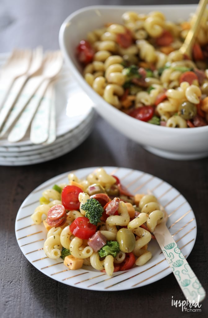 pasta salad served on a plate and in a white bowl.