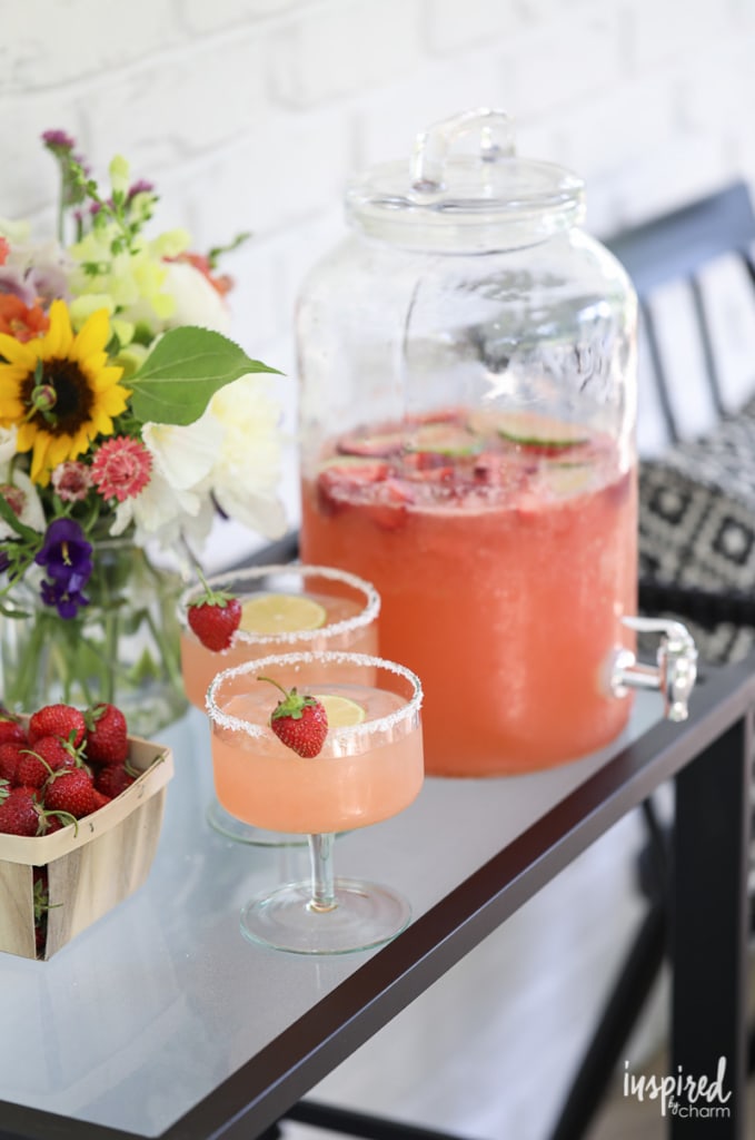 Strawberry Margarita Punch in glasses and serving container.