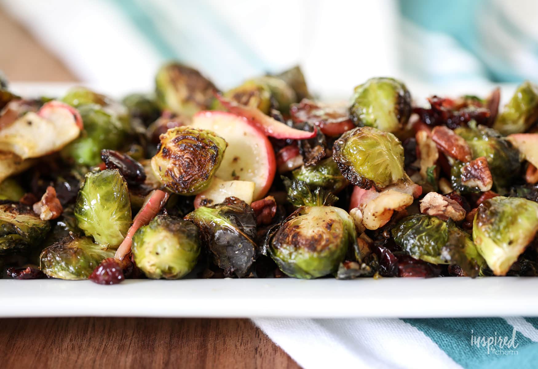 These Roasted Brussels Sprouts with apple, cranberries, and pecans make a tasty fall side dish. #sidedish #fall #recipe #roasted #brusselssprouts #apple #cranberries