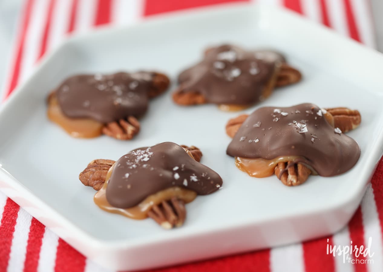 four Salted Turtle Candies on a plate.