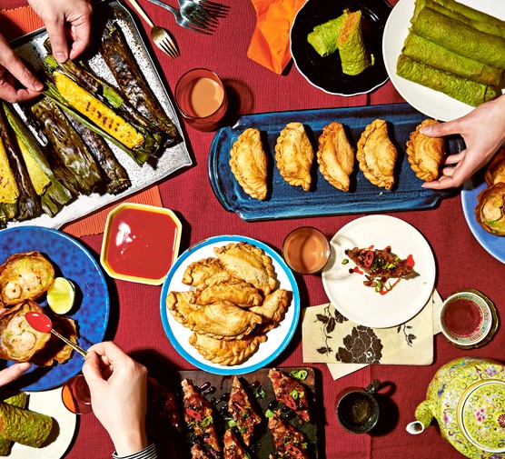 Sambal Shiok's spread of snacks with hands tucking in