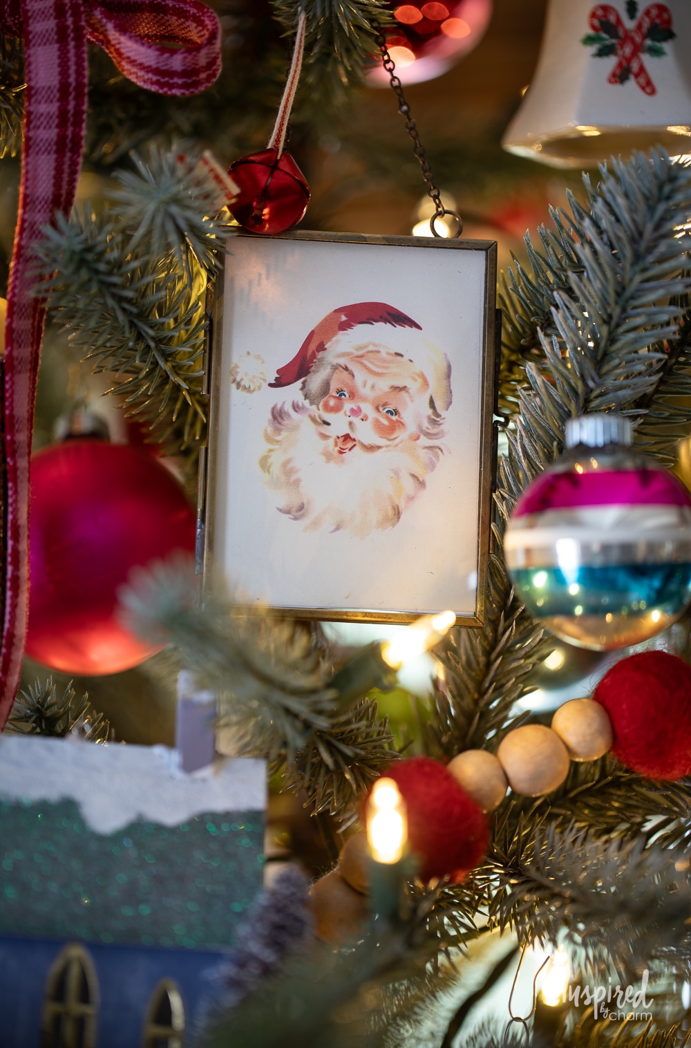 vintage santa ornament on a christmas tree.