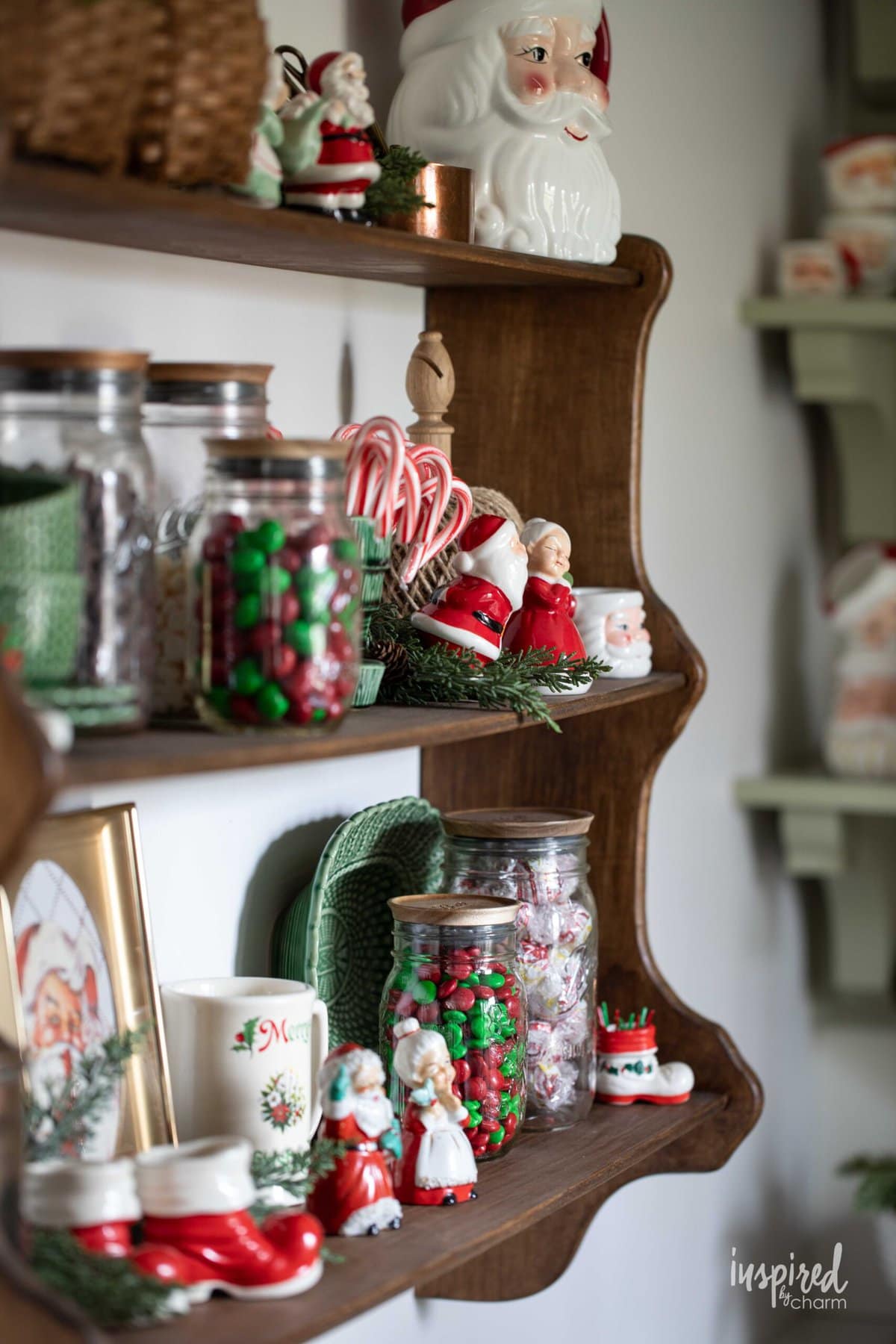 shelf filled with vintage ceramic Santas and mugs.