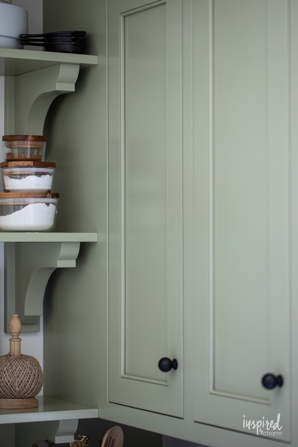 close up photo of cabinets painted in Sherwin-Williams sage.