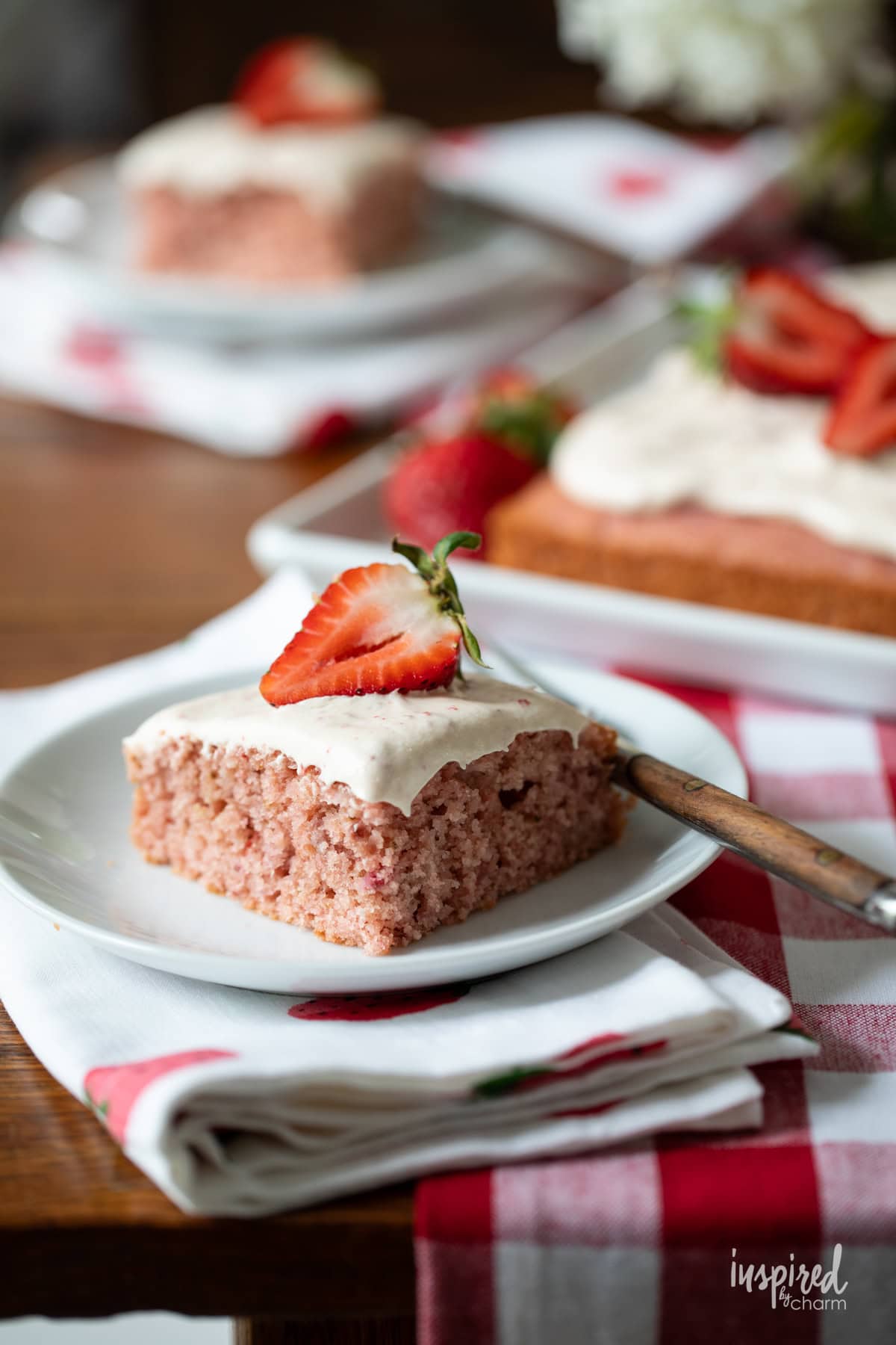 sliced of homemade strawberry cake on a plate with a fork.