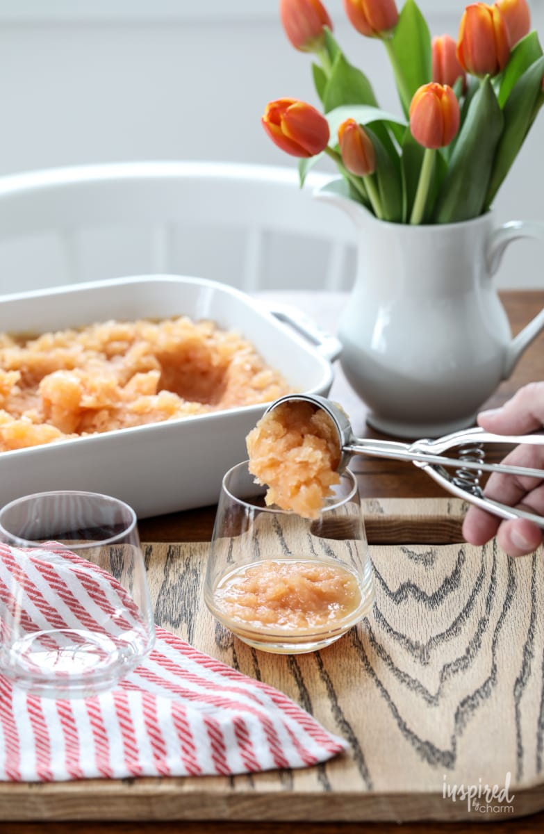 hand serving Frozen Old Fashioned Slush into a glass. 