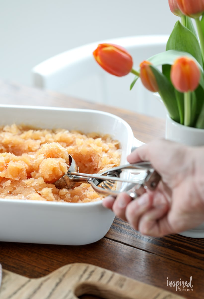 hand scooping Frozen Old Fashioned Slush with scoop. 