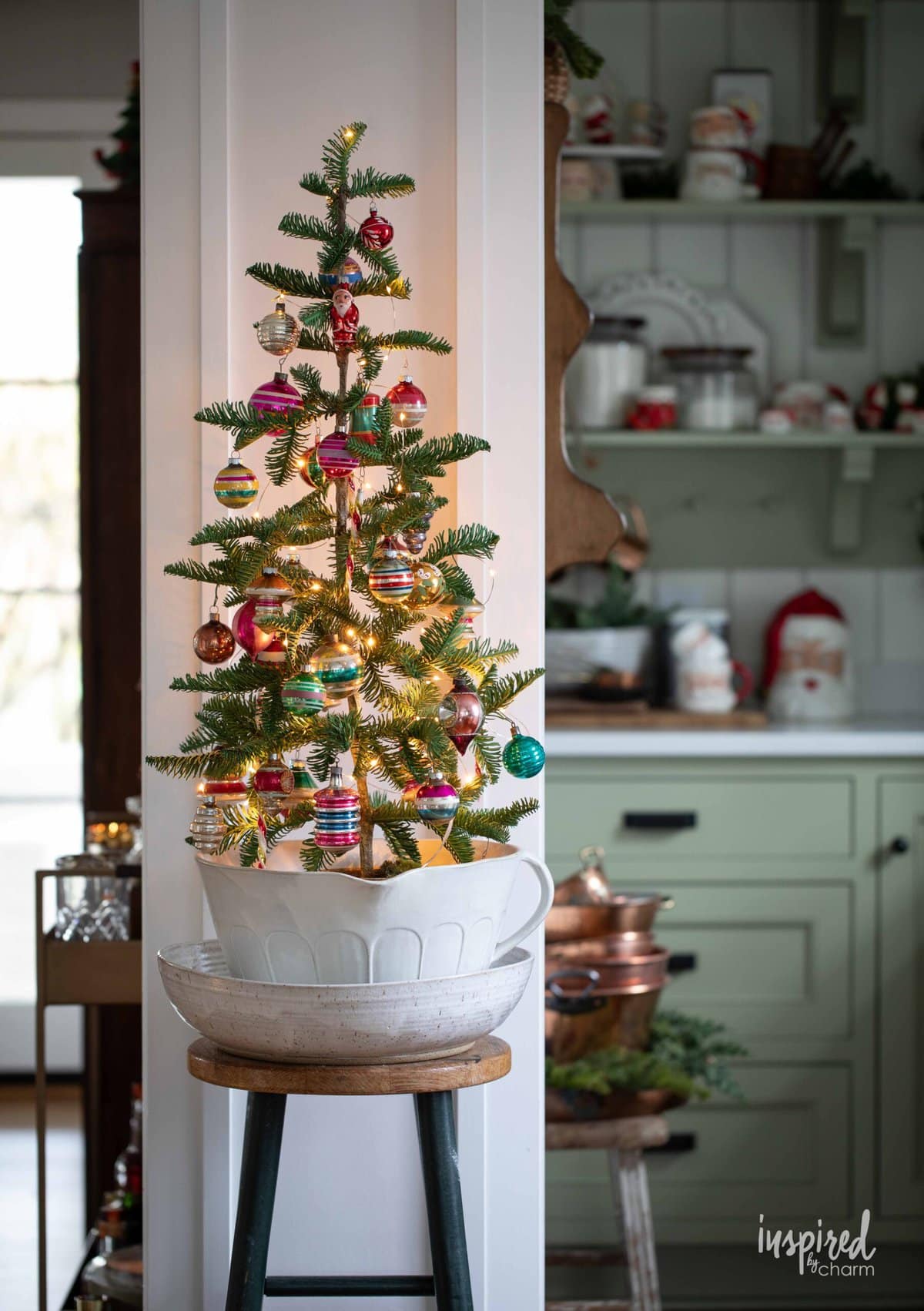 small christmas tree filled with vintage glass ornaments.