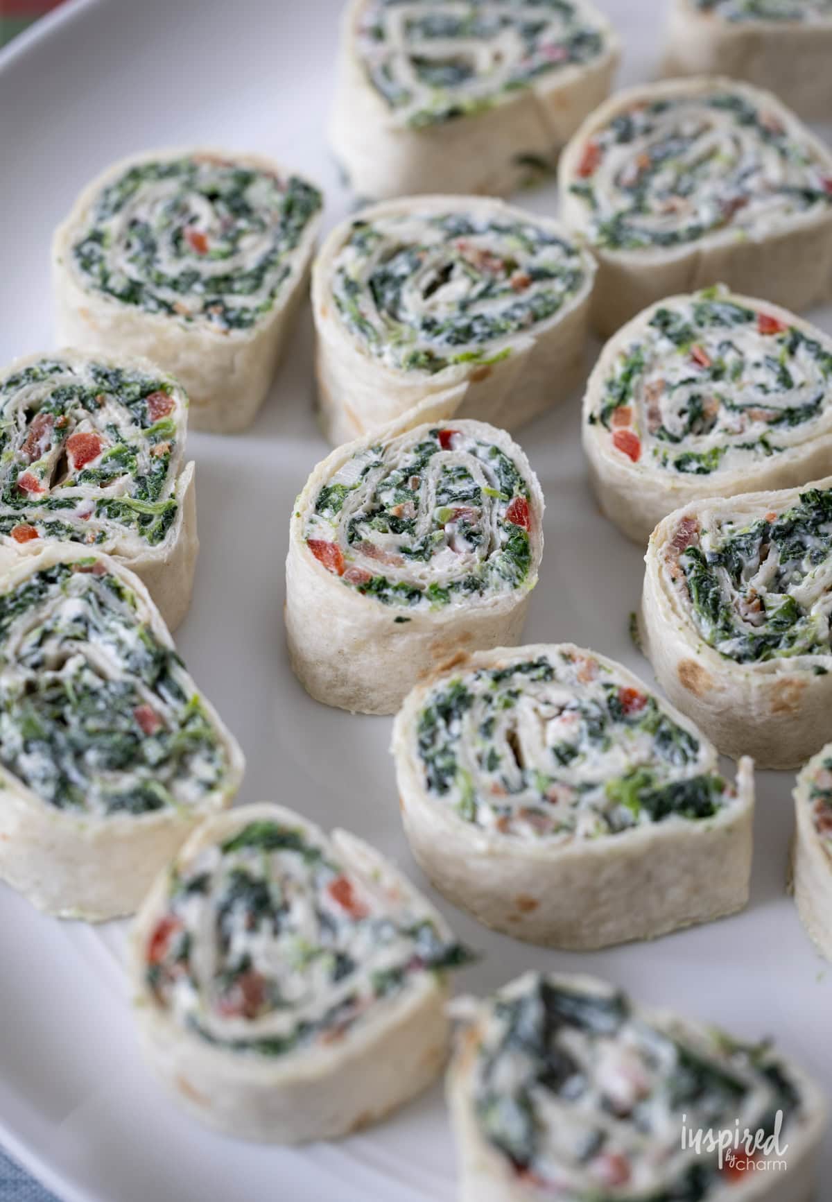 array of Spinach Roll-Ups on a plate.