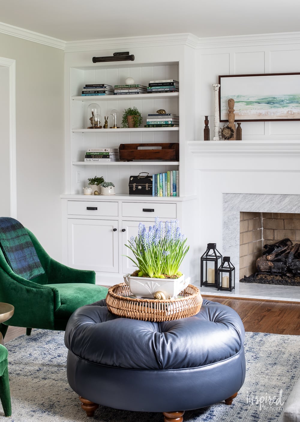 Sherwin Williams Agreeable Gray in living room with bookcase and fireplace.