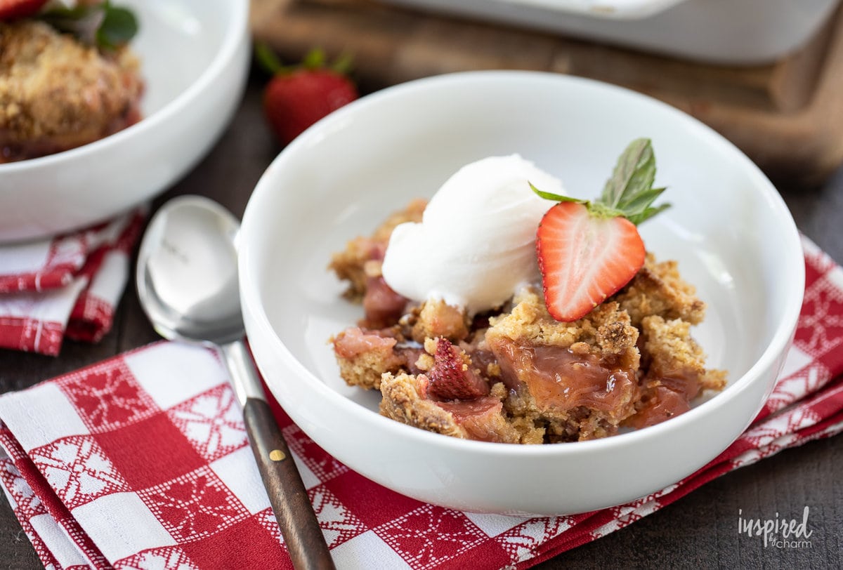 The Best Strawberry Crumble Recipe served in a bowl with vanilla ice cream.