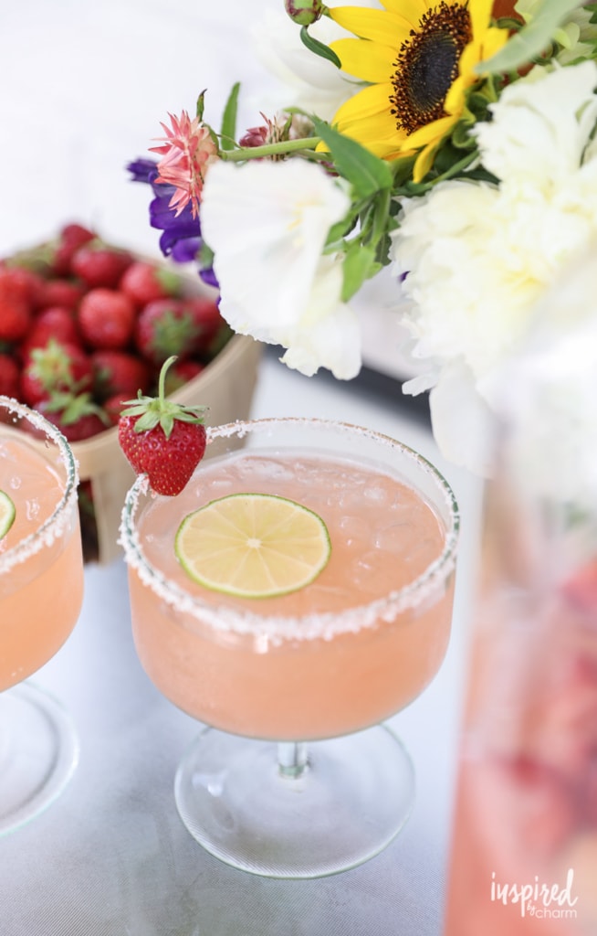 glass of Strawberry Margarita Punch  with a lime wheel.